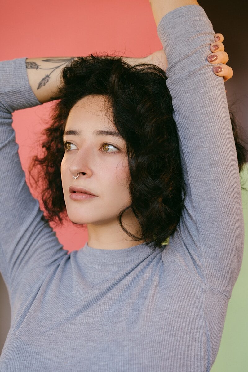 woman in pink crew neck shirt lying on bed